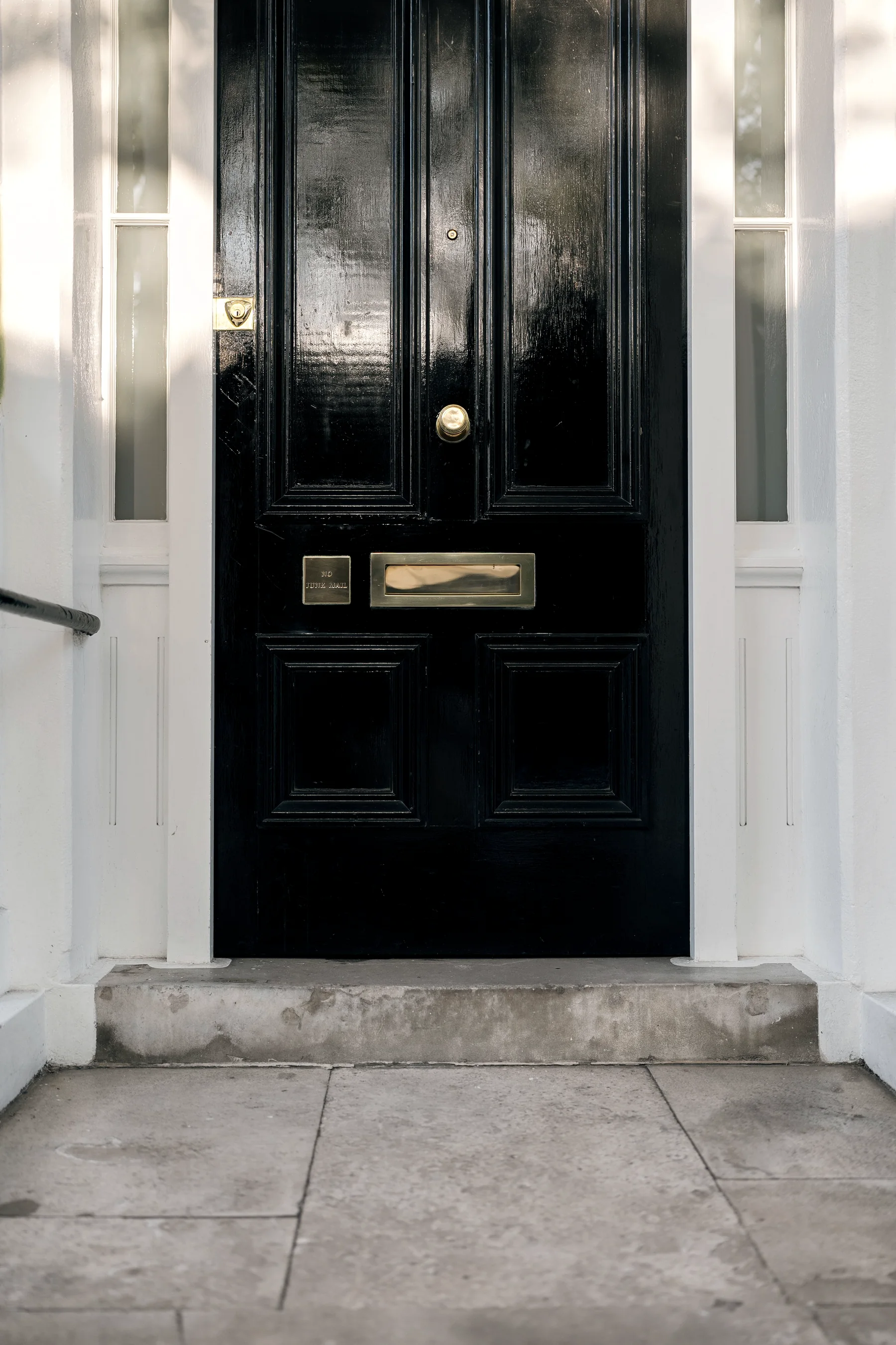 Classic black townhouse door with brass details in London